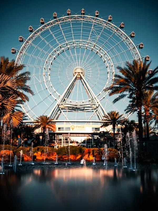White ferris wheel near body of water during daytime